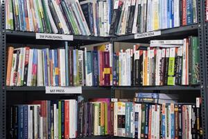 New Delhi, India, May 31 2024 - Variety of Books on shelf inside a book-stall at Delhi International Book Fair, Selection of books on display in Annual Book Fair at Bharat Mandapam complex photo
