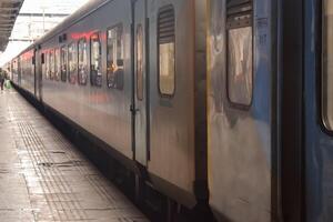 Amritsar, India, May 03 2024 - Indian railway train at Amritsar railway station platform during morning time, Colourful train at Amritsar, Punjab railway station photo