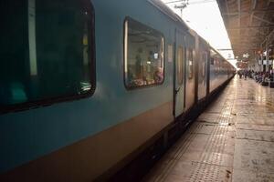 Amritsar, India, May 03 2024 - Indian railway train at Amritsar railway station platform during morning time, Colourful train at Amritsar, Punjab railway station photo