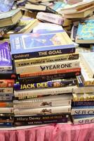New Delhi, India, May 17 2024 - Variety of Books on shelf inside a book-stall at Delhi International Book Fair, Selection of books on display in Annual Book Fair at Bharat Mandapam complex photo