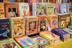 New Delhi, India, May 17 2024 - Variety of Books on shelf inside a book-stall at Delhi International Book Fair, Selection of books on display in Annual Book Fair at Bharat Mandapam complex photo