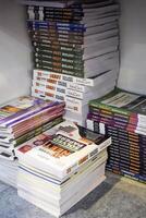 New Delhi, India, February 17 2024 - Variety of Books on shelf inside a book-stall at Delhi International Book Fair, Selection of books on display in Annual Book Fair at Bharat Mandapam complex photo