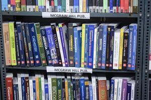 New Delhi, India, February 17 2024 - Variety of Books on shelf inside a book-stall at Delhi International Book Fair, Selection of books on display in Annual Book Fair at Bharat Mandapam complex photo