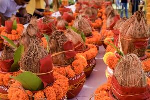 Kalash with coconut and mango leaf with floral decoration earthen pots containing sacred water. Kalash for hindu puja during Jagannath Temple Mangal Kalash Yatra, front view, closeup photo