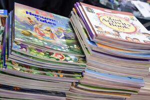 New Delhi, India, February 17 2024 - Variety of Books on shelf inside a book-stall at Delhi International Book Fair, Selection of books on display in Annual Book Fair at Bharat Mandapam complex photo