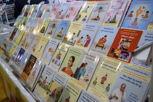 New Delhi, India, February 17 2024 - Variety of Books on shelf inside a book-stall at Delhi International Book Fair, Selection of books on display in Annual Book Fair at Bharat Mandapam complex photo