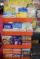 New Delhi, India, February 17 2024 - Variety of Books on shelf inside a book-stall at Delhi International Book Fair, Selection of books on display in Annual Book Fair at Bharat Mandapam complex photo