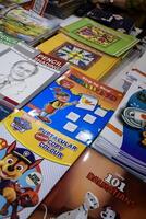 New Delhi, India, May 7 2024 - Variety of Books on shelf inside a book-stall at Delhi International Book Fair, Selection of books on display in Annual Book Fair at Bharat Mandapam complex photo