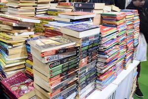 New Delhi, India, February 17 2024 - Variety of Books on shelf inside a book-stall at Delhi International Book Fair, Selection of books on display in Annual Book Fair at Bharat Mandapam complex photo