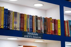 New Delhi, India, May 17 2024 - Variety of Books on shelf inside a book-stall at Delhi International Book Fair, Selection of books on display in Annual Book Fair at Bharat Mandapam complex photo