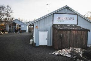 South Iceland, 2023 - welcome sign and tomato greenhouse building in Fridheimar - visitors friendly tomato farm.Famous travel destination on golden circle route photo