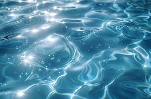 Clear blue water with gentle ripples and shimmering sunlight reflections, creating a serene effect. photo
