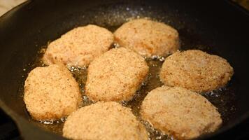 Fried cutlets in a frying pan with sunflower oil. Rustic menu. Traditional rustic food. Close-up. Homemade hamburger cutlets photo