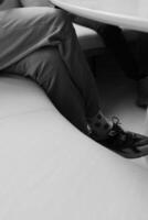 pair of legs in socks with a dollar pattern, black and white photo of the modern man in pants shoes and soks with dollar patern
