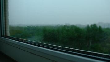 Raindrops on the window pane. Blurred background outside the window in the rain. photo