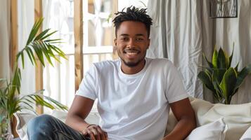 Young man wearing a blank t-shirt mockup while relaxing at home photo