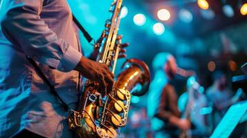 A musician playing the saxophone with the band on stage photo