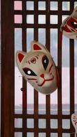 Traditional Japanese Kitsune Mask Hanging on Wooden Lattice with Light Filtering Through, Featuring Red and White Design Elements in Cultural Setting photo