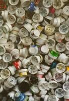 A pattern of many used and soiled nozzles from spray cans with aerosol paint. Background texture of the street art of drawing graffiti on the walls photo
