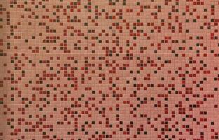 The texture of the wall, decorated with a mosaic of various small square tiles. Abstract pattern of ceramic tiles on the wall photo