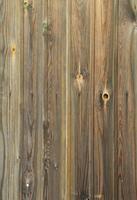 Old grunge dark brown wood panel pattern with beautiful abstract grain surface texture, vertical striped background or backdrop in architectural material decoration concepts, vintage or retro style photo