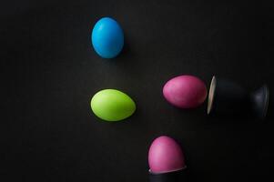 Painted eggs on a black background.Dietary protein diet. Minimalism. photo