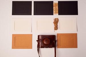 Storage and archiving of photos.Paper frames for photos, an old film camera in the case. Preserving your history. Photo Art.
