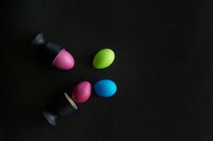 Painted eggs on a black background.Dietary protein diet. Minimalism. photo