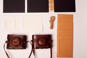 Storage and archiving of photos.Paper frames for photos, an old film camera in the case. Preserving your history. Photo Art.