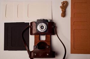 Storage and archiving of photos.Paper frames for photos, an old film camera in the case. Preserving your history. Photo Art.