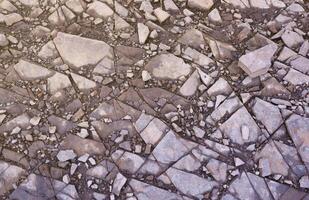 Background of shattered stony stones surface in mountain area. Texture with natural light photo