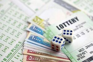 Green lottery tickets and iranian money bills on blank with numbers for playing lottery photo