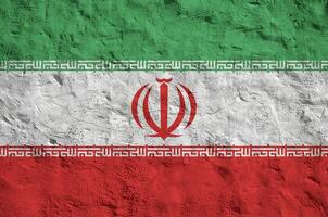 Iran flag depicted in bright paint colors on old relief plastering wall. Textured banner on rough background photo