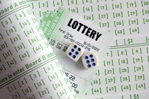 Lottery tickets and dice on blank bills with numbers for playing lottery photo