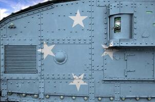 Micronesia flag depicted on side part of military armored tank closeup. Army forces conceptual background photo