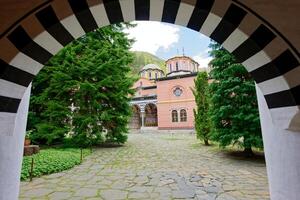View of the Rila Monastery, the largest and most famous Eastern Orthodox monastery in Bulgaria. Famous tourist attractions. Place of worship. photo