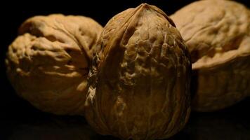 Walnuts in rotation on black background video