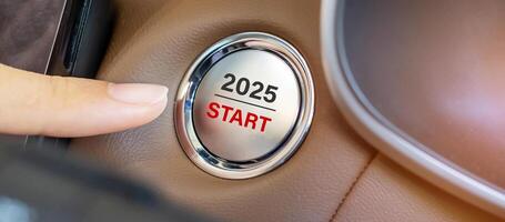 Finger press a car ignition button with 2025 START text inside automobile. New Year New You, forecast, resolution, motivation, change, goal, vision, innovation and planning concept photo