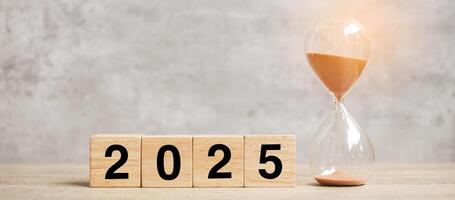 2025 text with hourglass on table. Resolution, time, plan, goal, motivation, reboot, countdown and New Year holiday concepts photo