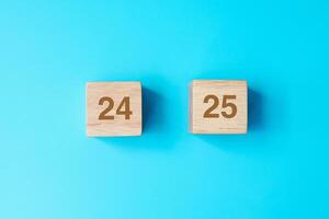 wooden cube block with 2025 text on blue background. Resolution, plan, review, goal, start and New Year holiday concepts photo