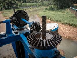 a simple mechanism for using iron gears to control water flow for irrigation photo