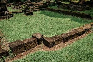 the arrangement of ancient temple stones in a park that has not yet been completely restored photo