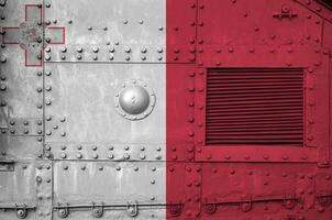 Malta flag depicted on side part of military armored tank closeup. Army forces conceptual background photo