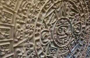 Ancient Mayan Calendar or Aztec calendar with rough relief surface photo
