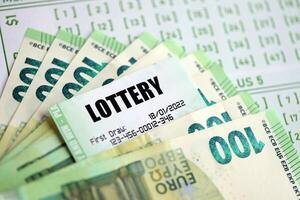 Green lottery tickets and euro money bills on blank with numbers for playing lottery photo