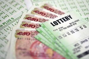 Green lottery tickets and Great Britain pounds money bills on blank with numbers for playing lottery photo