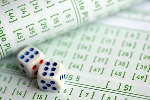Lottery tickets and dice on blank bills with numbers for playing lottery photo