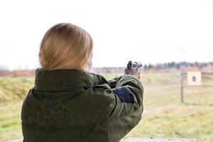 Man shooting at a target. Unformal shooting range photo