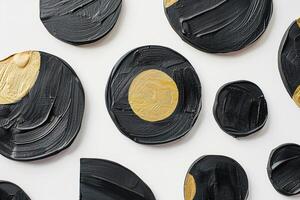 Captivating array of abstract circles, featuring textured black oil paint with accents of gold, arranged in minimalist design that exudes contemporary elegance and luxury. Modern print. photo