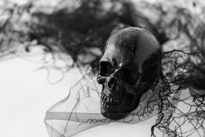 Eerie Halloween scene captures a sinister black skull enveloped in tangled cobwebs, creating a chilling atmosphere, ideal for spooky themed content with a stark, moody background. photo
